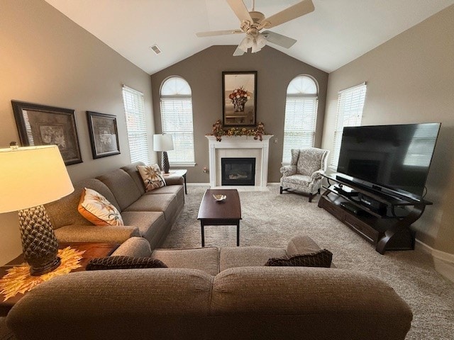 carpeted living room featuring vaulted ceiling and ceiling fan