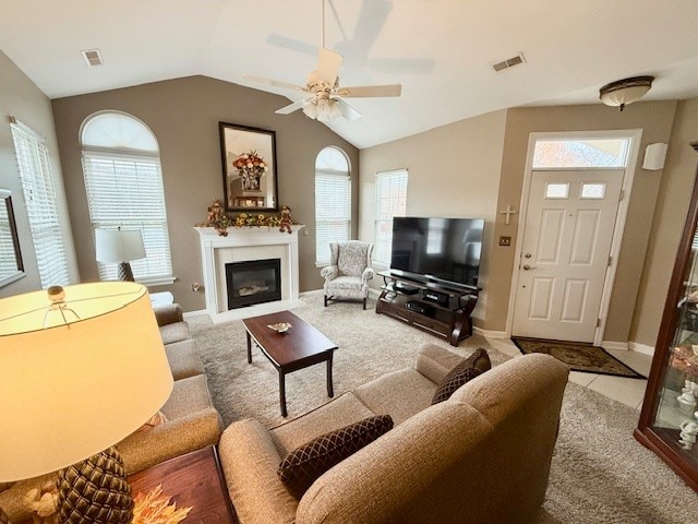 living room featuring vaulted ceiling, ceiling fan, and plenty of natural light