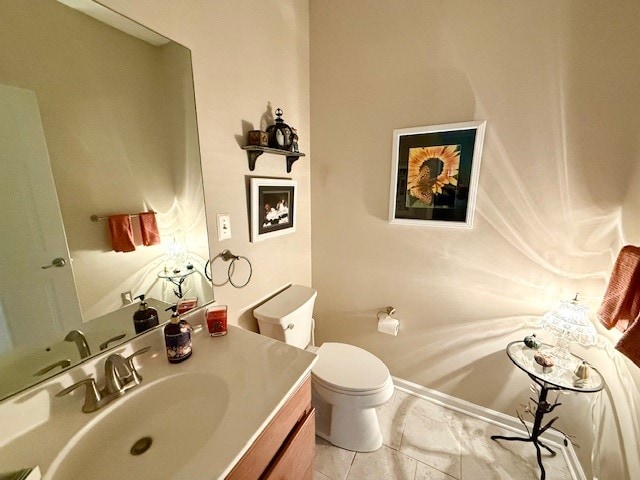 bathroom featuring tile patterned flooring, vanity, and toilet