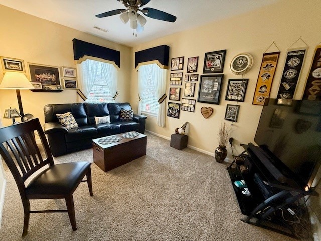 carpeted living room featuring ceiling fan