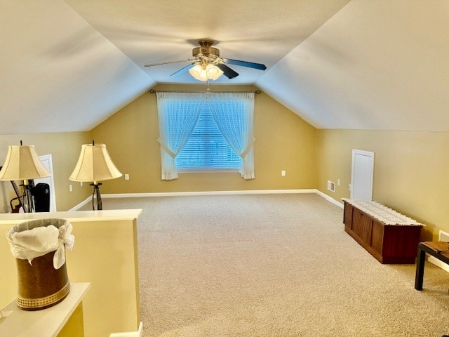 additional living space with ceiling fan, vaulted ceiling, and carpet