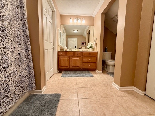 bathroom with vanity, tile patterned flooring, and toilet