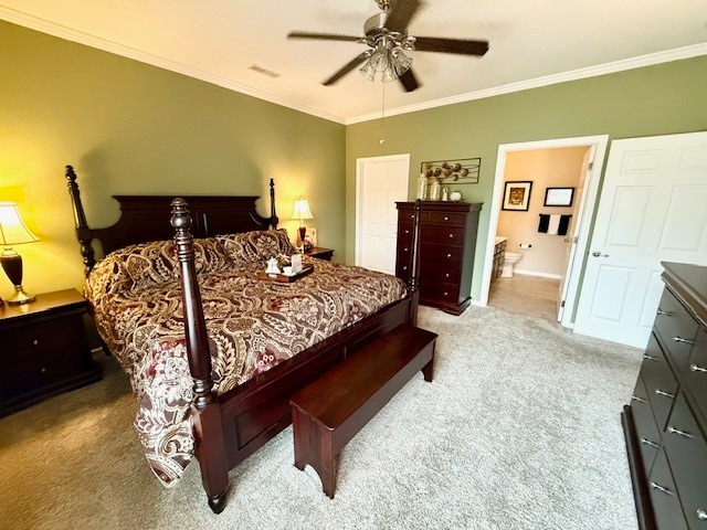 bedroom featuring connected bathroom, light colored carpet, ceiling fan, and crown molding