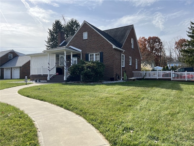 view of front of house with covered porch, a garage, and a front lawn