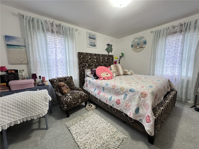 carpeted bedroom with multiple windows