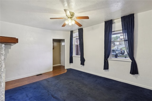 unfurnished room with ceiling fan and dark hardwood / wood-style floors