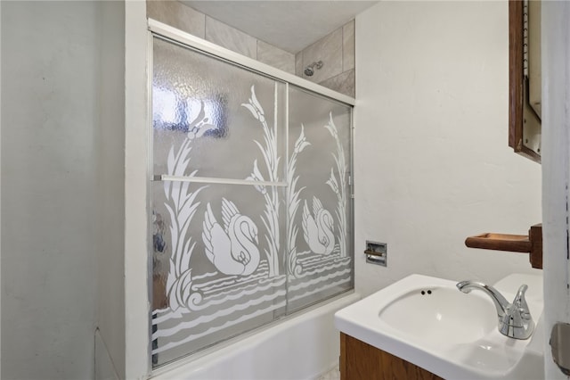 bathroom featuring vanity and bath / shower combo with glass door