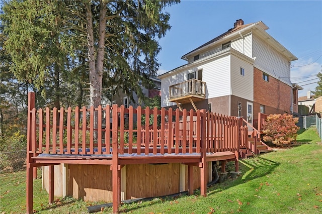 back of property featuring a yard and a deck