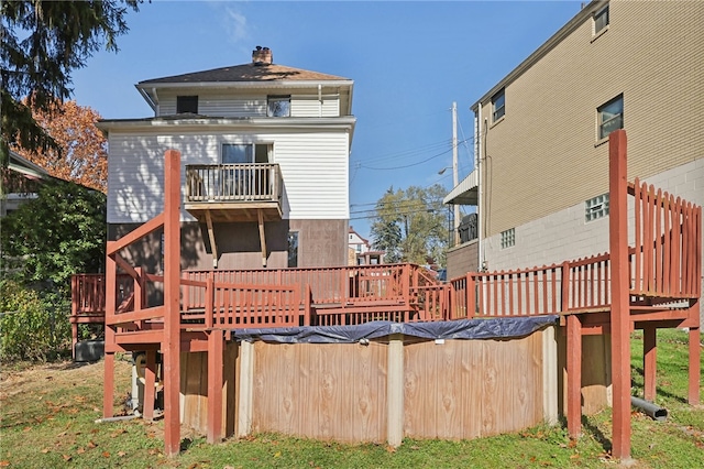 back of house with a wooden deck