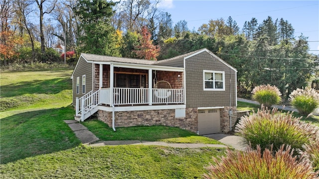 view of front of property featuring a garage, a front yard, and a porch