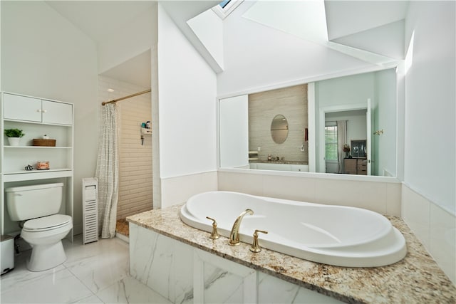 bathroom featuring toilet, independent shower and bath, and a skylight