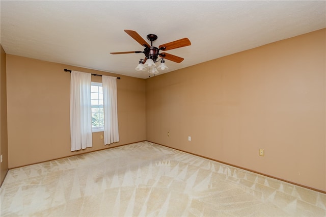 carpeted spare room with a textured ceiling and ceiling fan