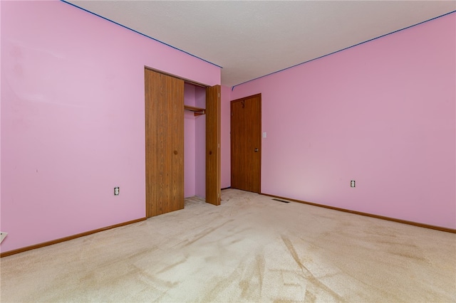 carpeted spare room featuring a textured ceiling