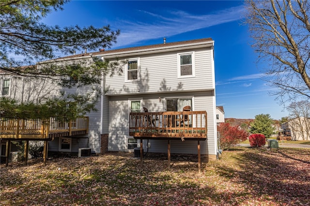 rear view of house featuring cooling unit and a deck