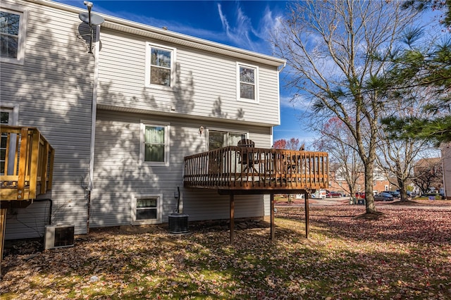 rear view of house with a wooden deck and central AC