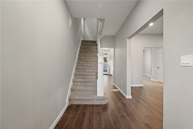 stairs featuring wood-type flooring