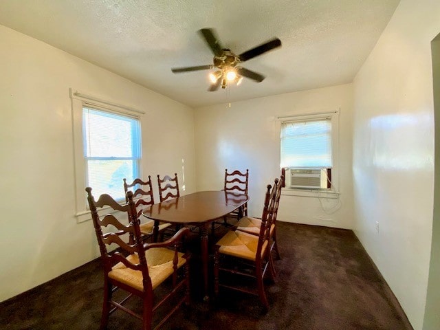 dining space with ceiling fan, dark colored carpet, cooling unit, and a textured ceiling