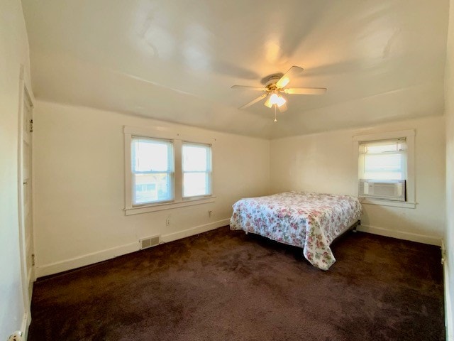 bedroom with dark colored carpet and ceiling fan