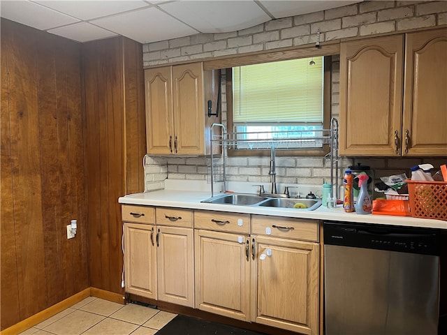 kitchen featuring light tile patterned flooring, sink, a drop ceiling, dishwasher, and decorative backsplash