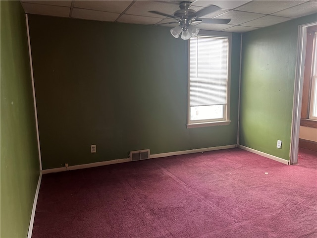 carpeted spare room with a paneled ceiling and ceiling fan