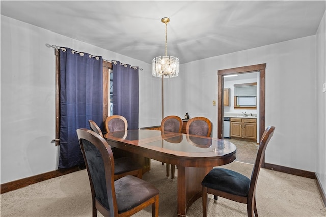 carpeted dining area featuring sink and an inviting chandelier