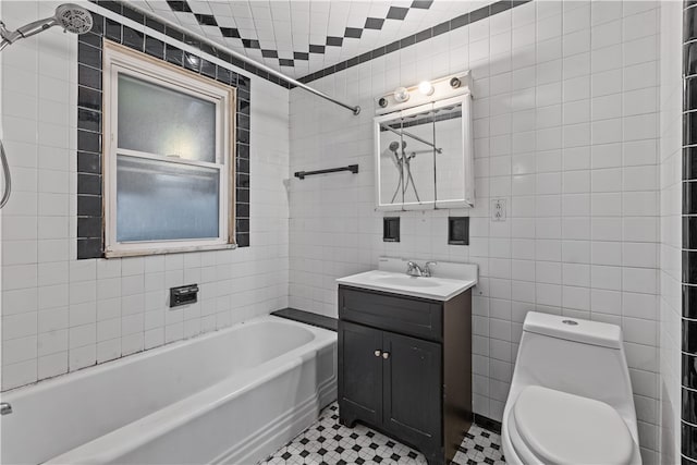 full bathroom featuring tile walls, tile patterned floors, vanity, shower / bathing tub combination, and toilet