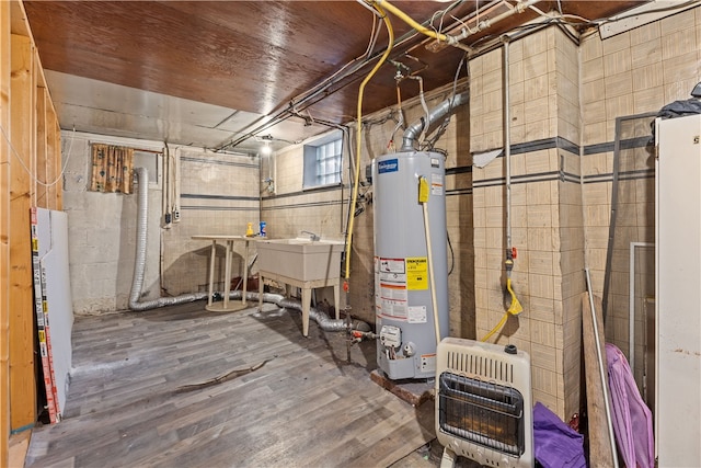 utility room featuring heating unit and gas water heater