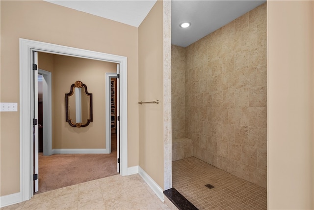 bathroom featuring tile patterned floors and a tile shower