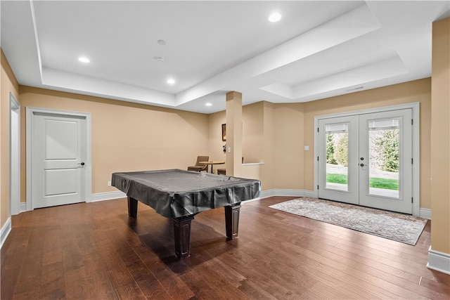 game room featuring french doors, dark wood-type flooring, billiards, and a tray ceiling