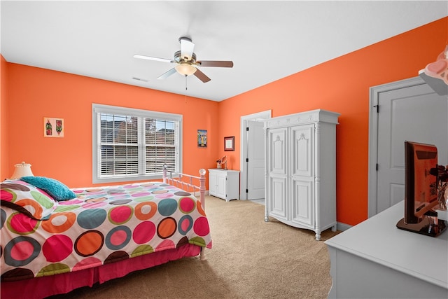 carpeted bedroom featuring ceiling fan