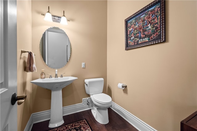 bathroom with hardwood / wood-style floors and toilet