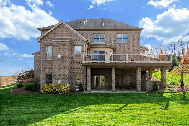 rear view of property featuring a patio area, a yard, french doors, and a deck