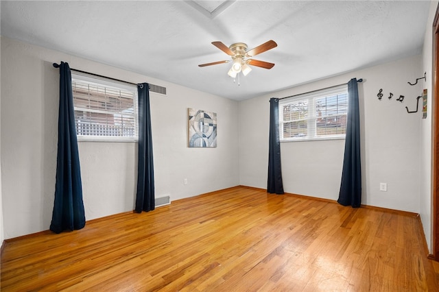 unfurnished room featuring ceiling fan and light hardwood / wood-style flooring