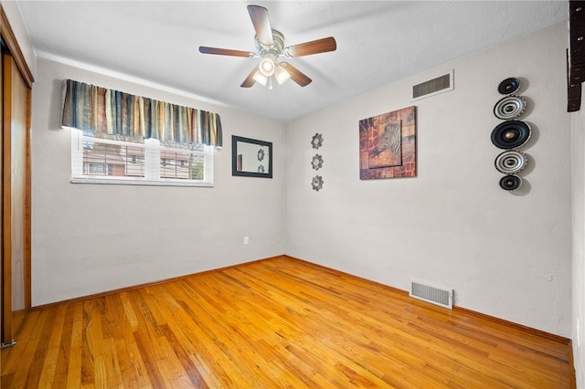 spare room featuring hardwood / wood-style flooring and ceiling fan