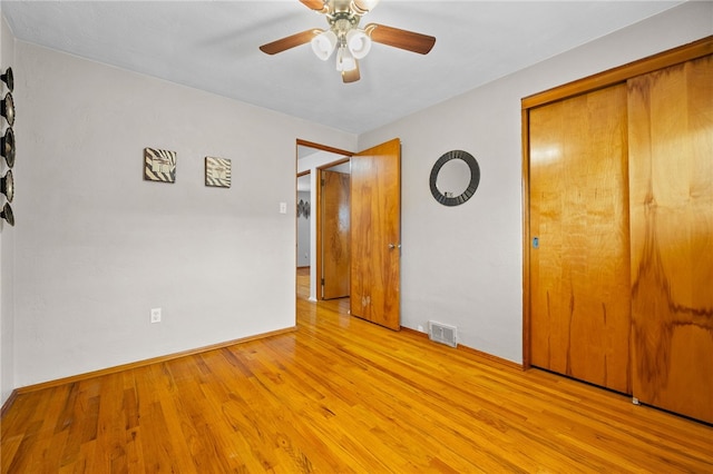 unfurnished bedroom with ceiling fan, a closet, and light hardwood / wood-style flooring