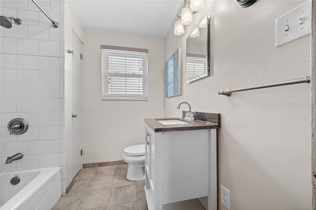 full bathroom with vanity, tiled shower / bath combo, and toilet