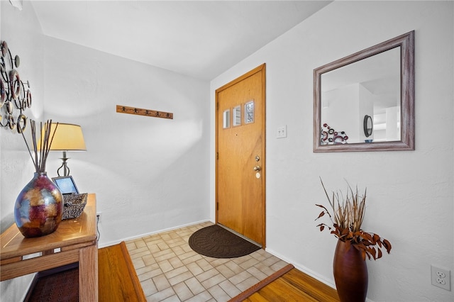 entryway with hardwood / wood-style flooring