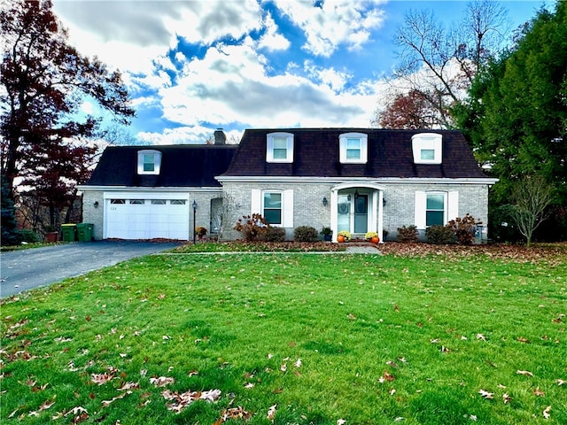 cape cod house featuring a garage and a front lawn