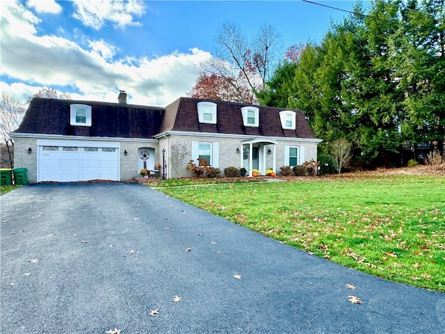 cape cod-style house featuring a front lawn and a garage