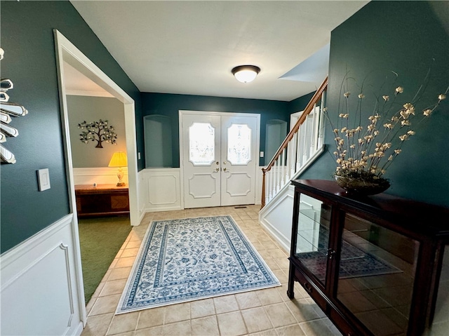 tiled foyer entrance featuring french doors