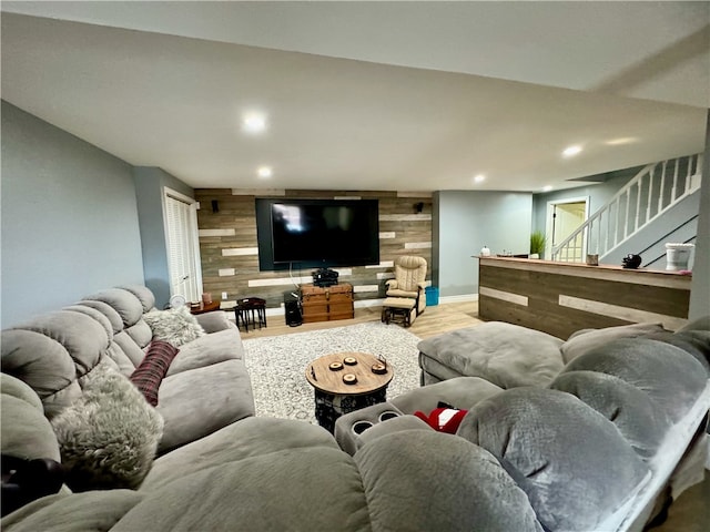 living room featuring wood-type flooring and wooden walls