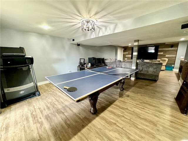 rec room featuring wood-type flooring and wooden walls