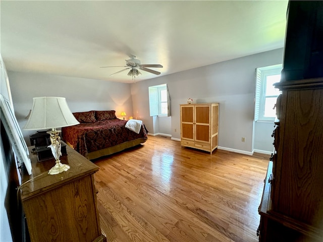 bedroom with ceiling fan and light hardwood / wood-style flooring