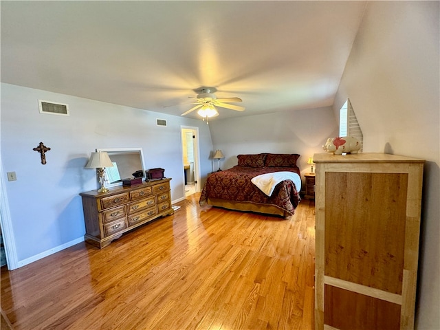 bedroom with hardwood / wood-style floors, ceiling fan, and vaulted ceiling