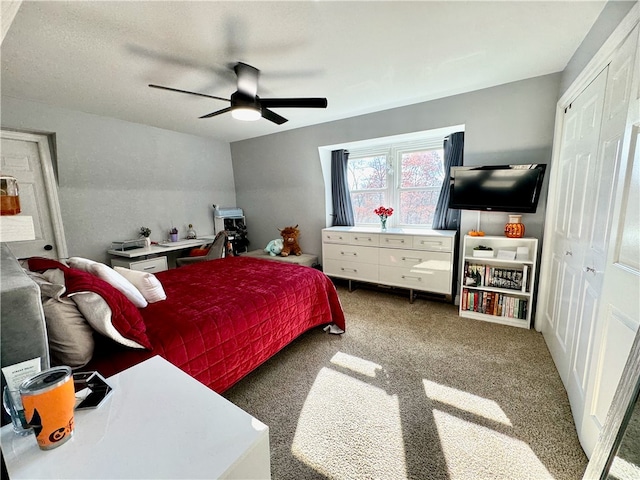 bedroom with a closet, ceiling fan, and carpet floors