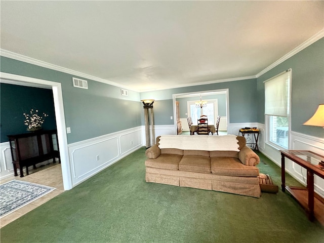 bedroom with carpet flooring, ornamental molding, and a notable chandelier