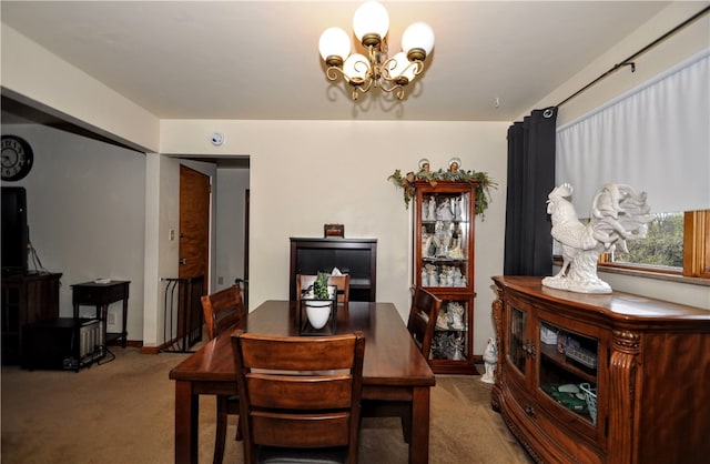 dining room with a chandelier and carpet floors