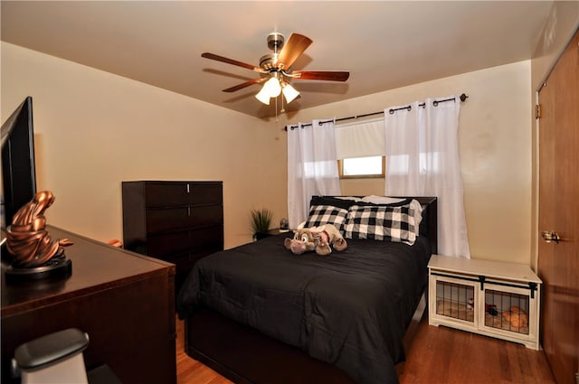 bedroom with dark wood-type flooring and ceiling fan