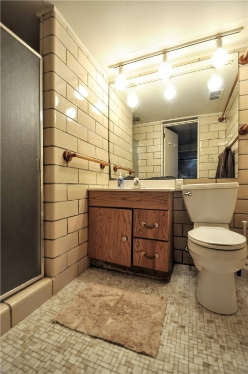 bathroom with walk in shower, vanity, and toilet