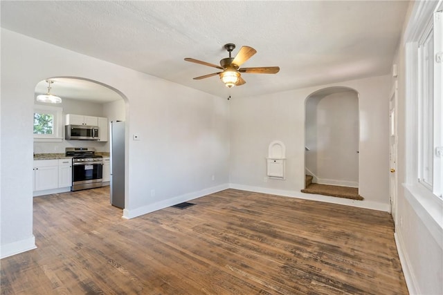 empty room featuring ceiling fan and dark wood-type flooring